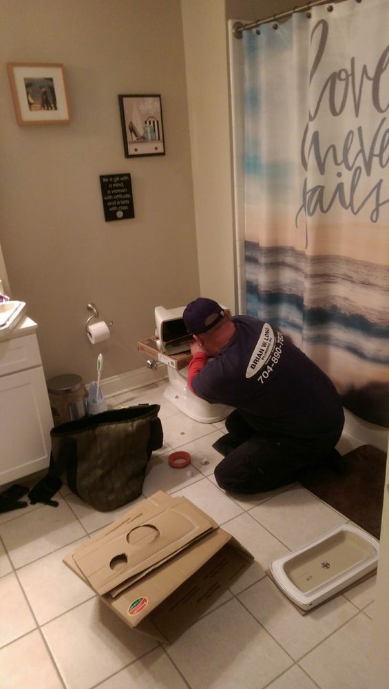 Brian Long working on a plumbing project in a Charlotte home